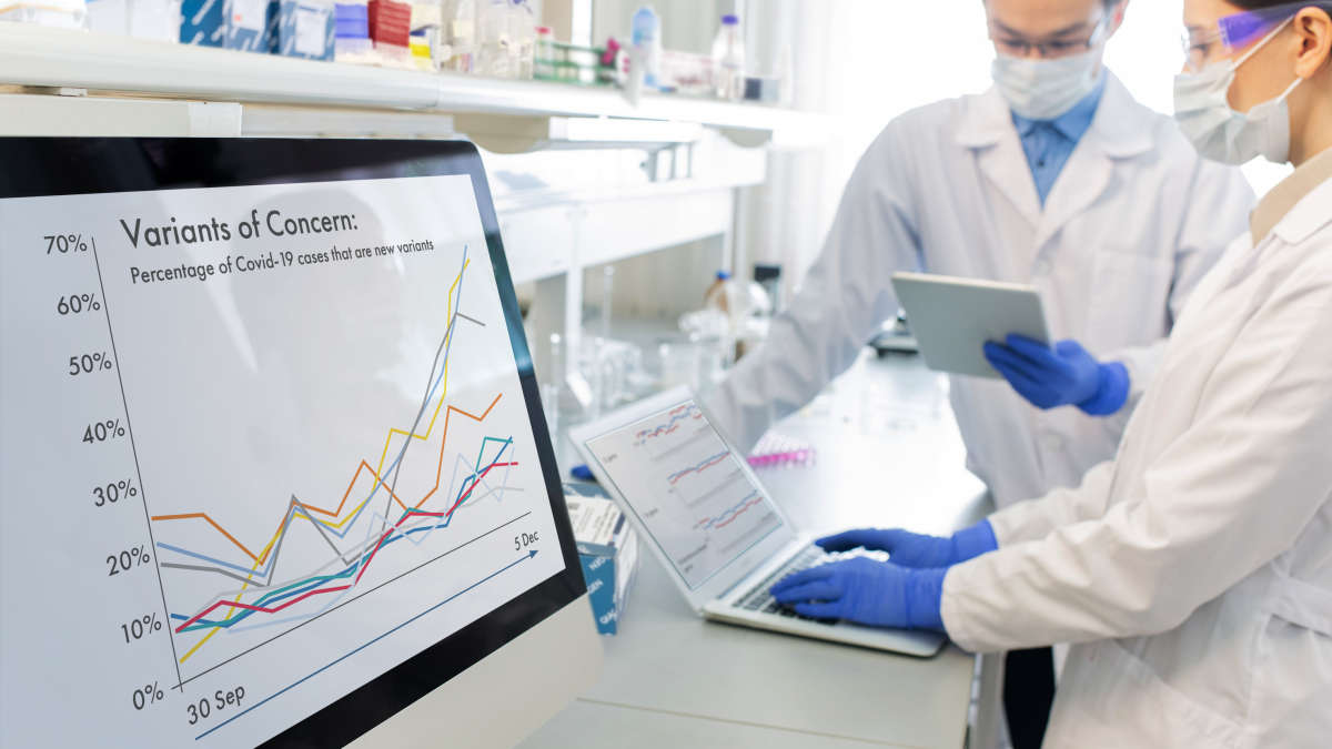 2 scientists comparing notes in a lab