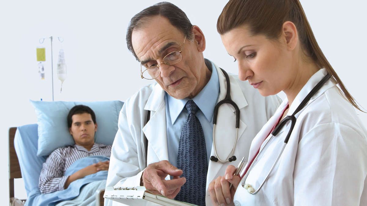 QFT Transplant, Doctors discussing a patient's medical Chart