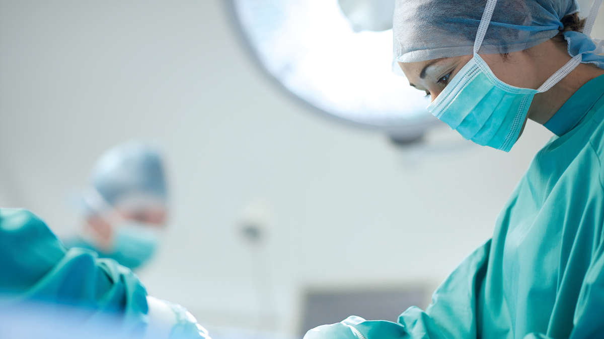 Female surgeon at the operating table