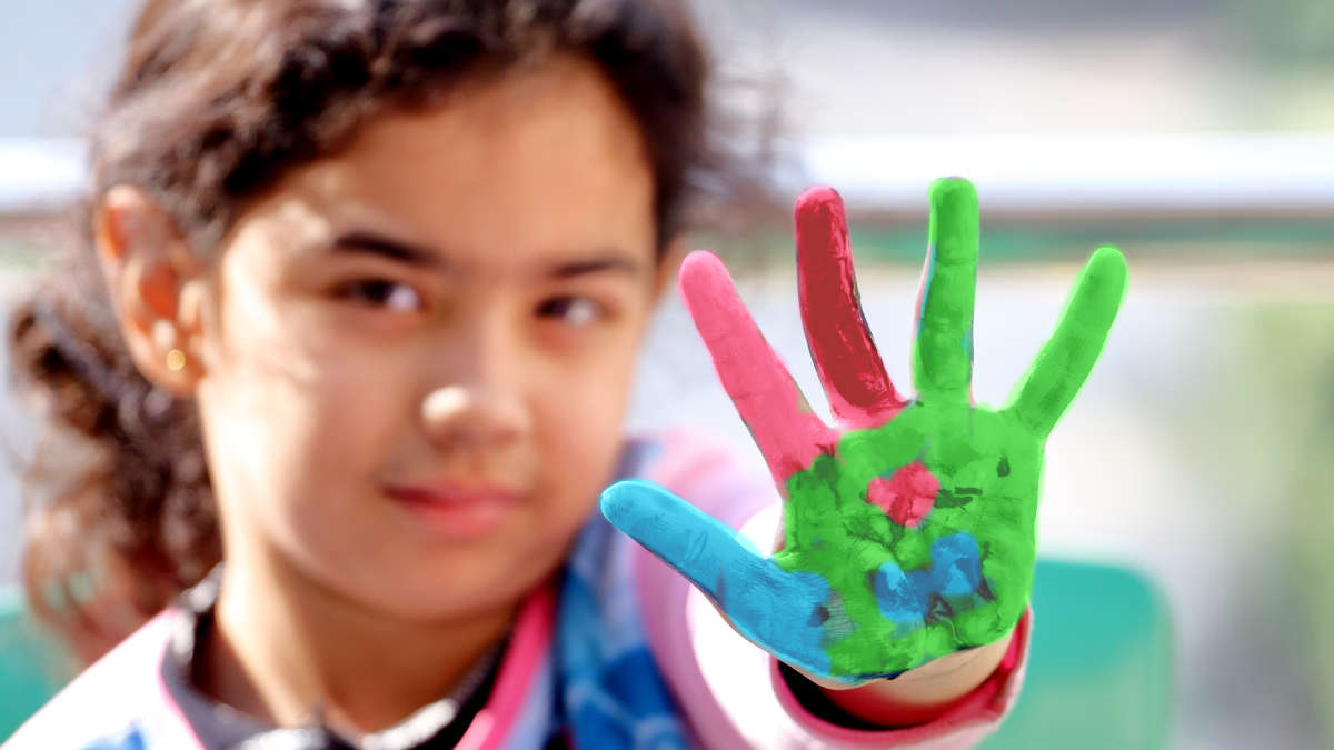 a girl with painted palm of her hand