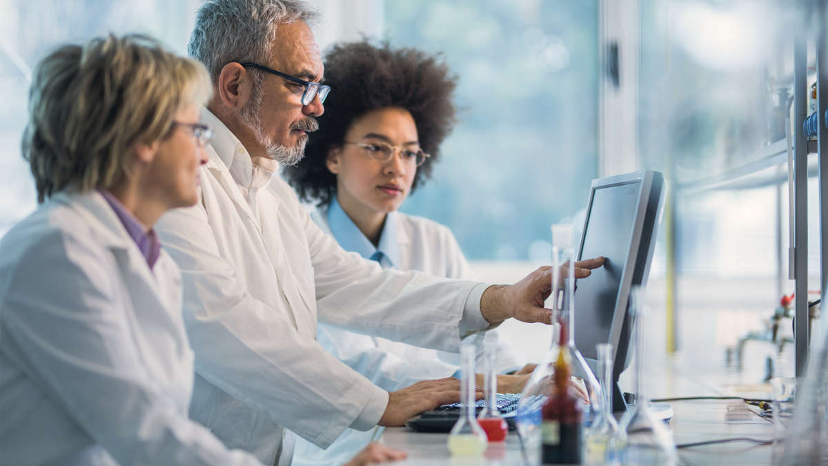 people working in lab looking at data