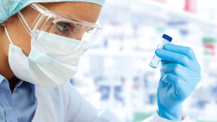 Female sientist holding a tube