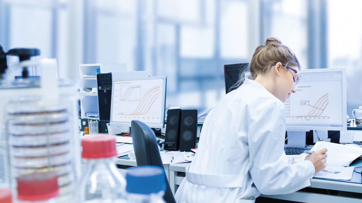 Real-time qPCR, female scientist with documents