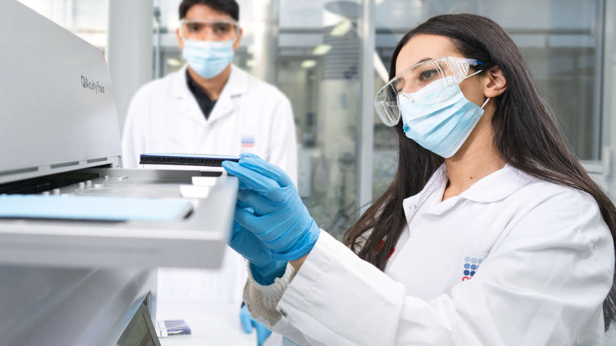 QIAcuity, digital PCD, dPCR, Labworker handling the instrument, loading tips, Chaimae Safi, Amit Singh, mask, wearing masks, labcoat