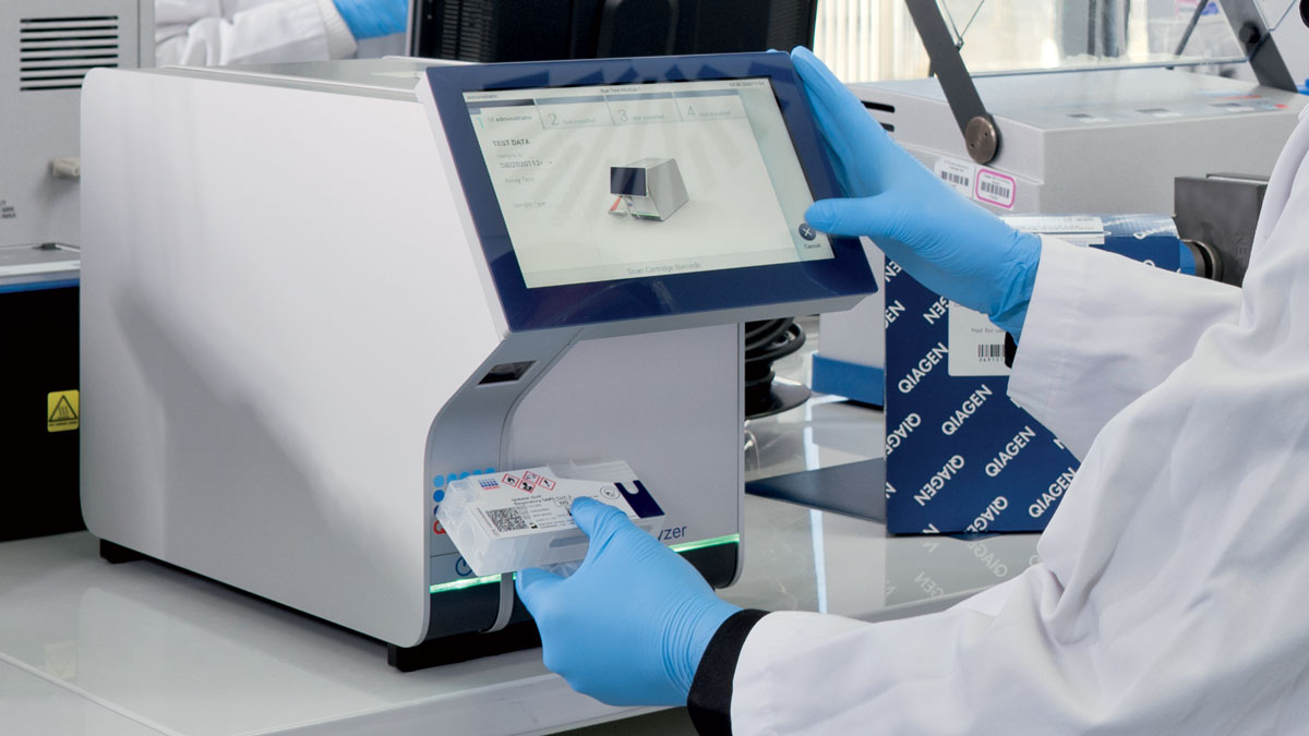 Lab worker handling the instrument