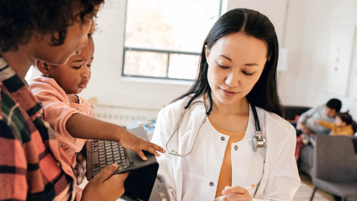 Female doctor in consolidation with mother and child