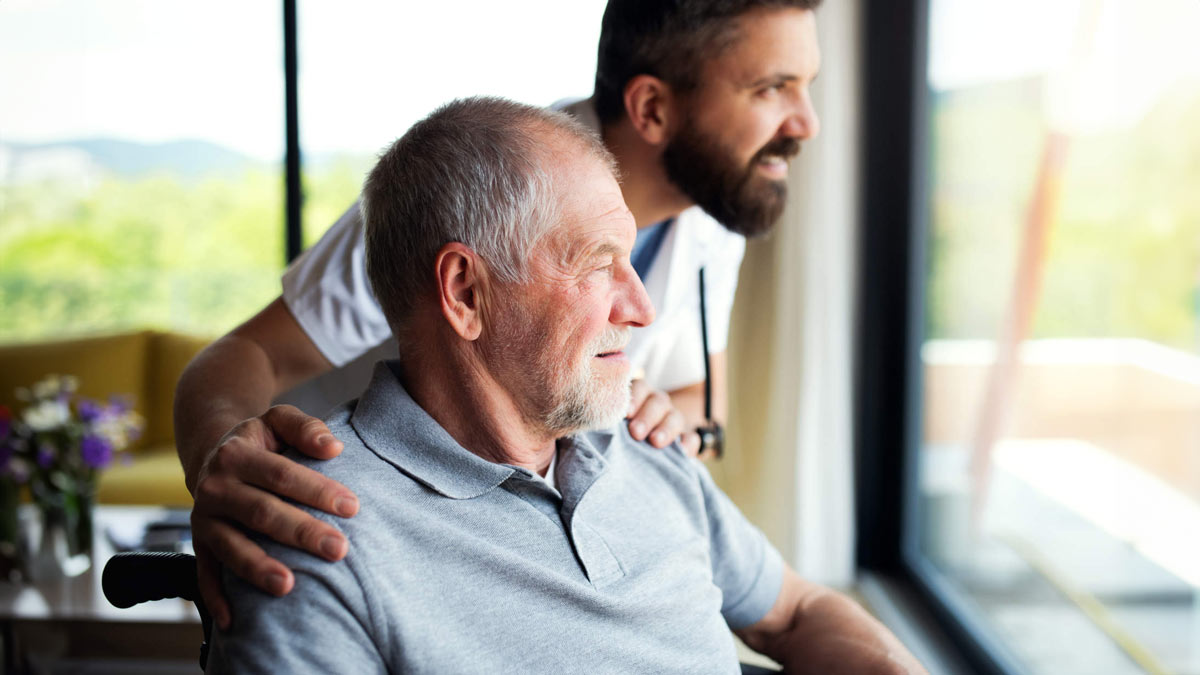 mature male patient, caretaker, wheeled chair