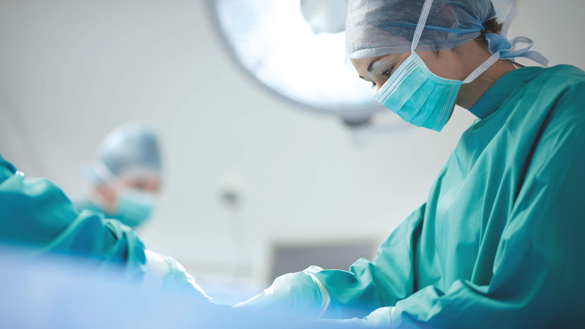 Female surgeon at the operating table