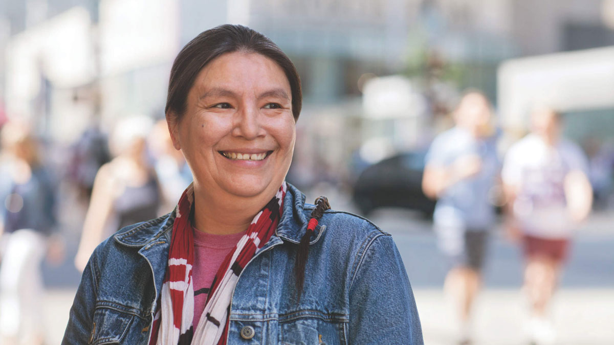 QFT, woman on street smiling