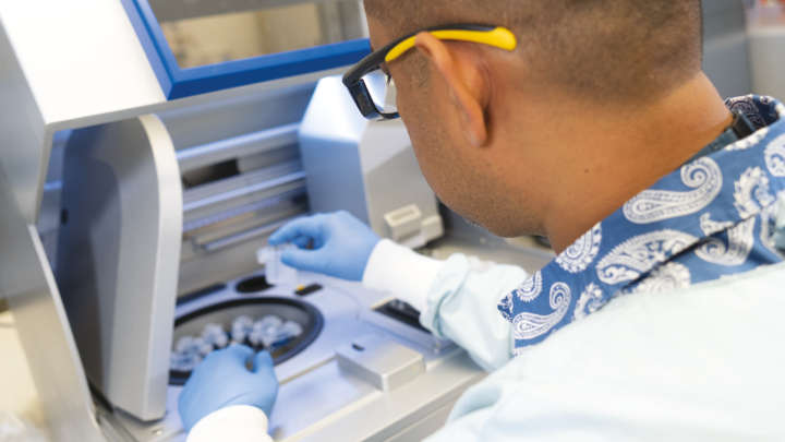 scientist conducts research on the qiagen machine